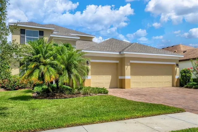 an aerial view of a residential houses with outdoor space and river