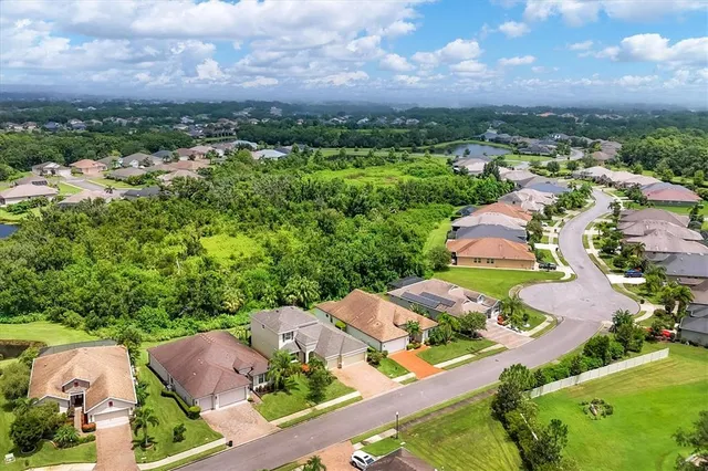 an aerial view of a house with a garden and lake view