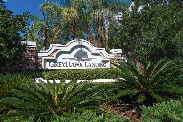 an aerial view of a house with a swimming pool and outdoor seating