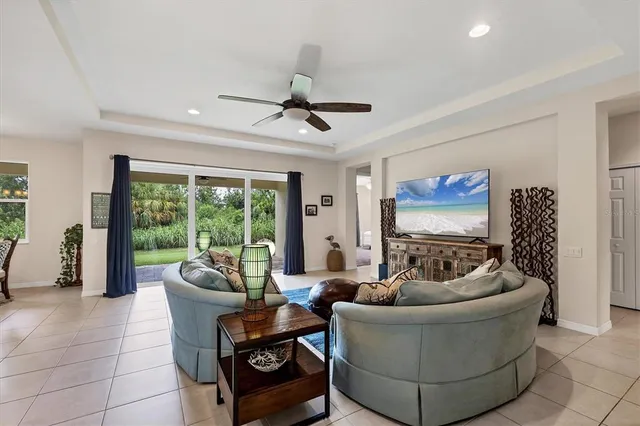 a living room with furniture and kitchen view
