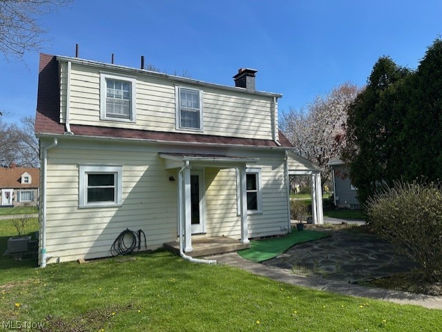 317 Ewing Road Youngstown, OH 44512 - Photo 4 of 15 Back of house with a lawn