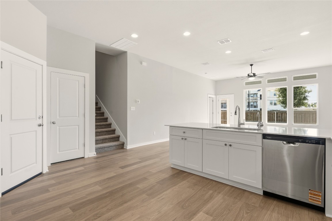 2206 Luna Azul View, Unit 78 Round Rock, TX 78664 - Photo 8 of 31 Kitchen featuring stainless steel dishwasher, recessed lighting, white cabinets, a ceiling fan, and light wood-type flooring