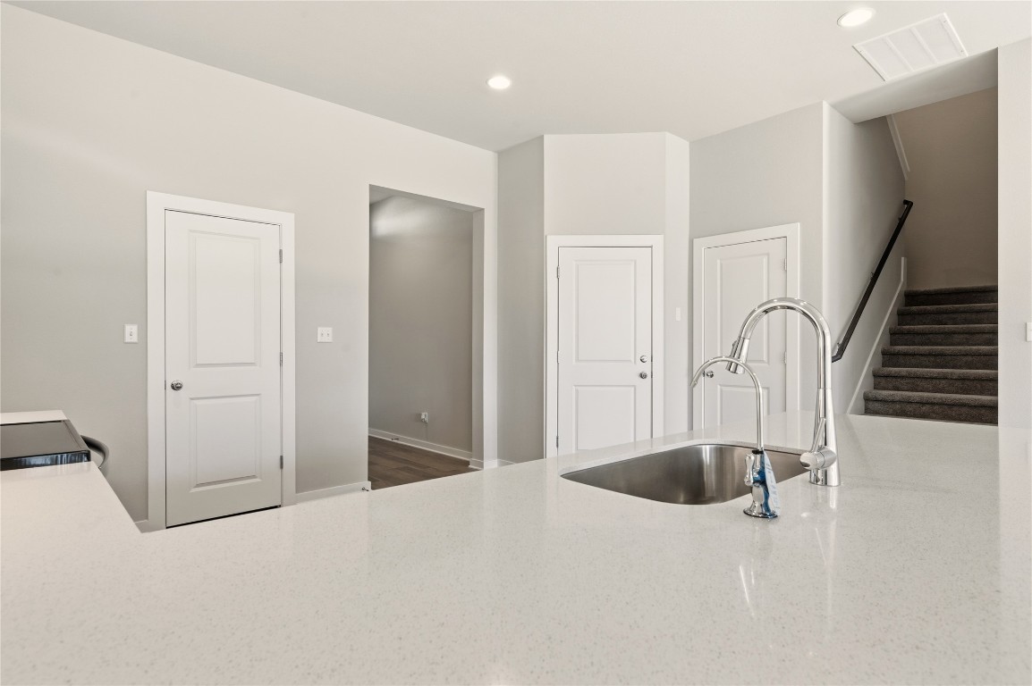 2206 Luna Azul View, Unit 78 Round Rock, TX 78664 - Photo 9 of 31 Kitchen with recessed lighting, light stone counters, and electric range