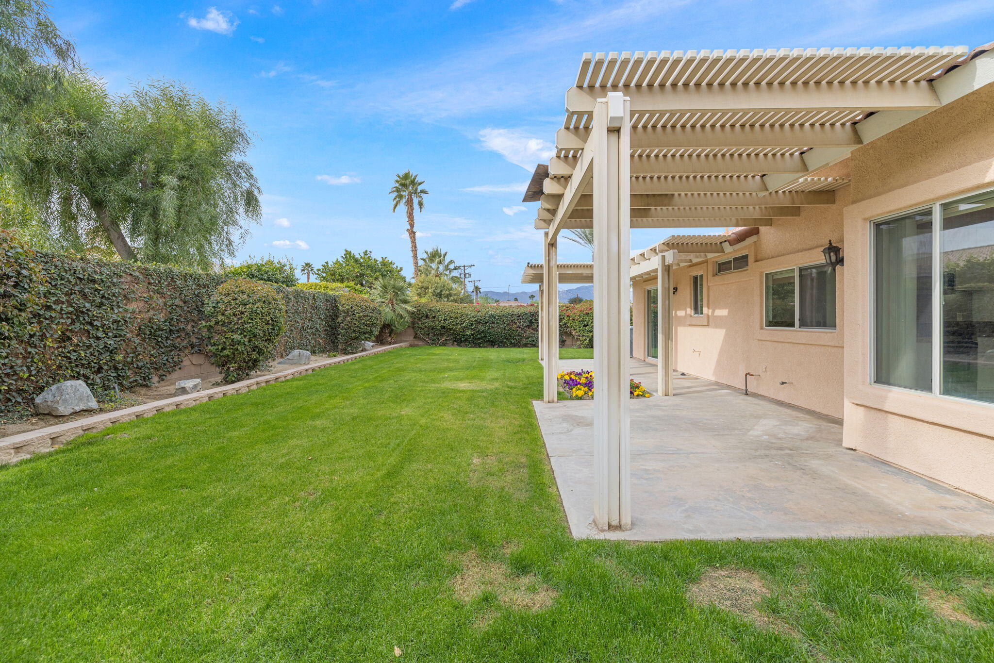 80601 Declaration Avenue Indio, CA 92201 - Photo 12 of 52 a view of a house with a yard and potted plants
