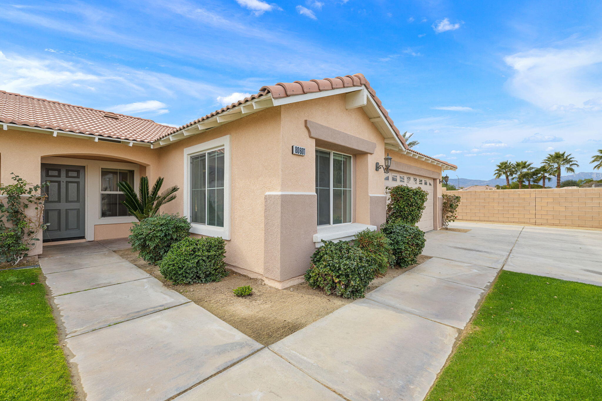 80601 Declaration Avenue Indio, CA 92201 - Photo 13 of 52 a front view of a house with a yard