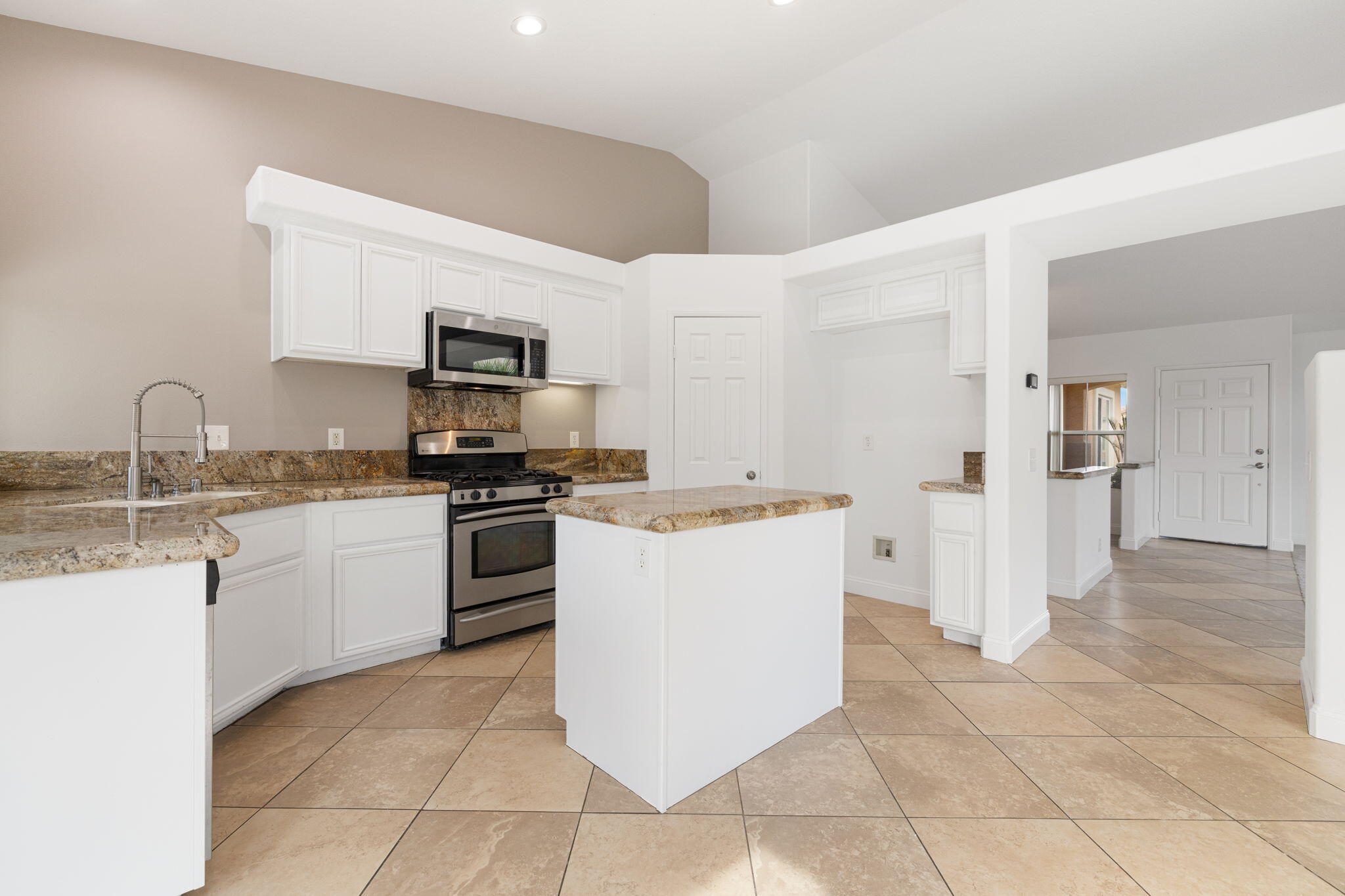80601 Declaration Avenue Indio, CA 92201 - Photo 22 of 52 a kitchen with a sink a stove top oven and cabinetry