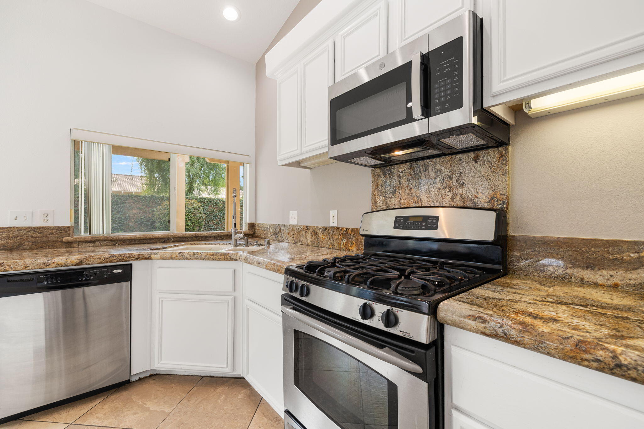 80601 Declaration Avenue Indio, CA 92201 - Photo 24 of 52 a kitchen with stainless steel appliances granite countertop a stove and a microwave