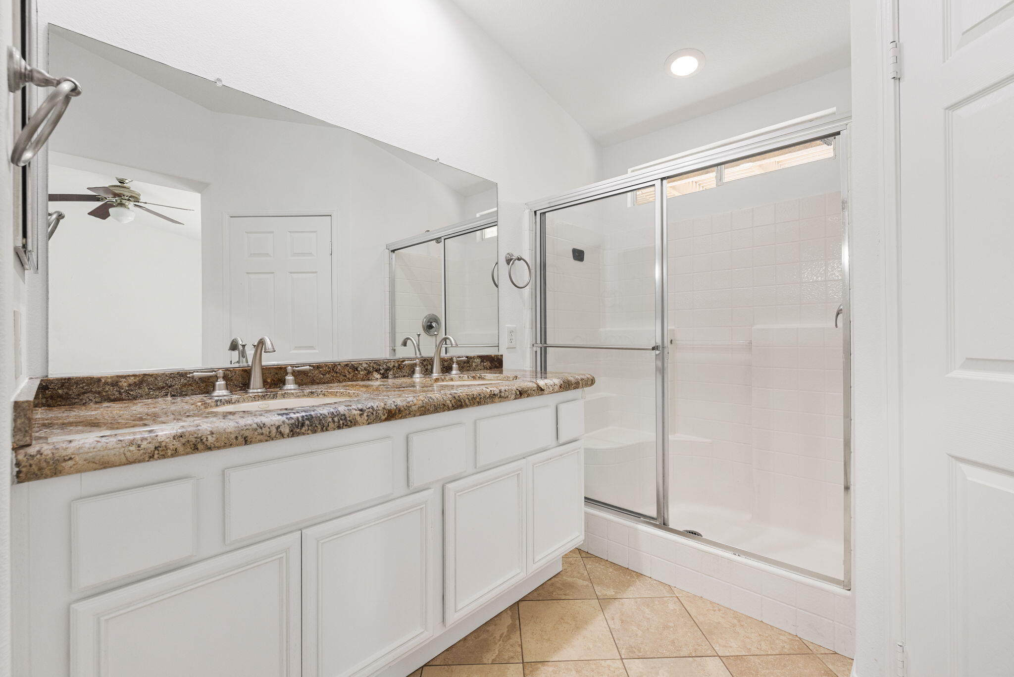 80601 Declaration Avenue Indio, CA 92201 - Photo 29 of 52 a bathroom with a granite countertop sink a mirror and a shower