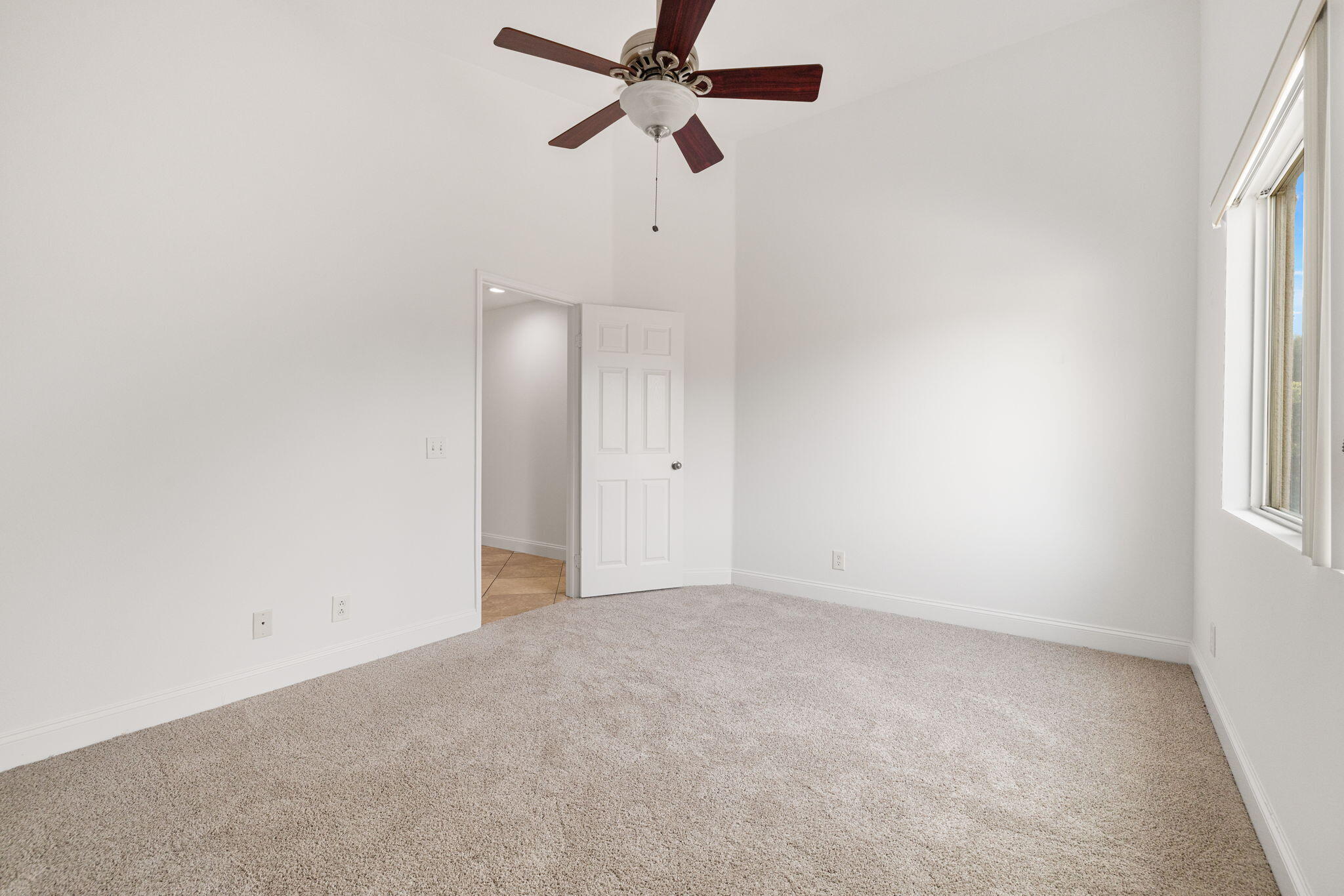 80601 Declaration Avenue Indio, CA 92201 - Photo 31 of 52 an empty room with a window and a fan