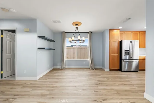 a view of a kitchen with a refrigerator and a stove