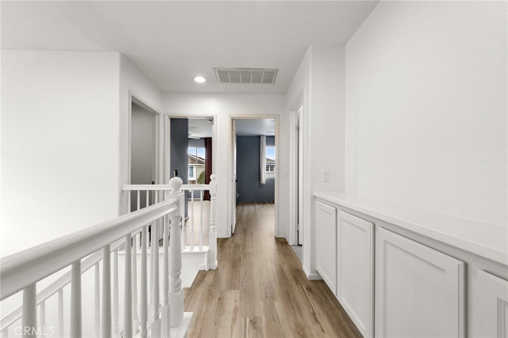 431 West Bay Street, Unit S Costa Mesa, CA 92627 - Photo 24 of 34 a view of a hallway with wooden floor