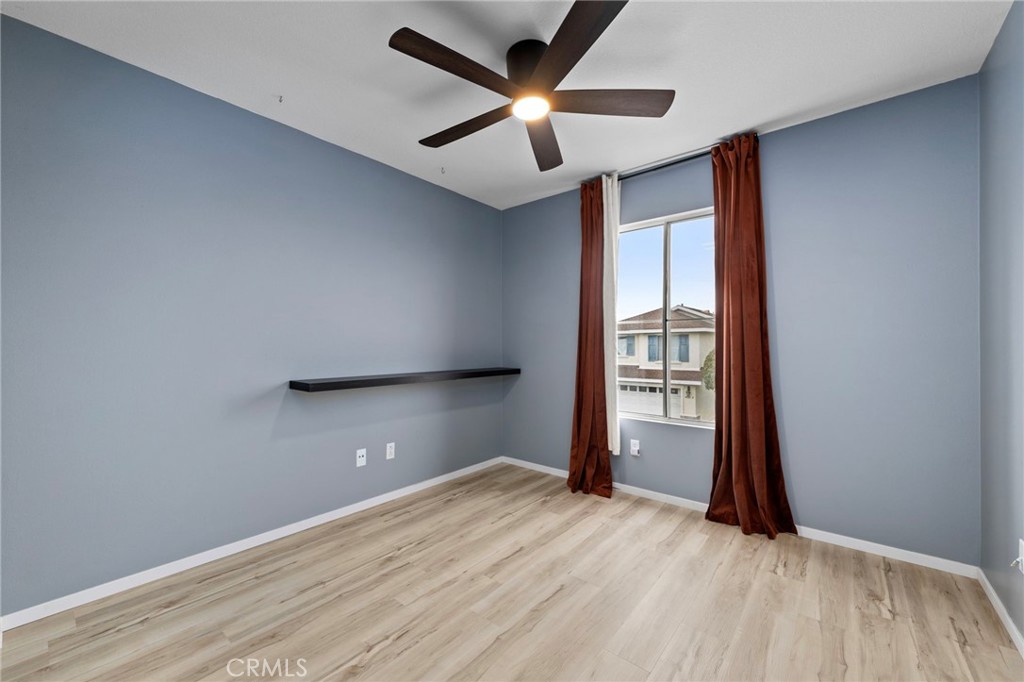 431 West Bay Street, Unit S Costa Mesa, CA 92627 - Photo 27 of 34 an empty room with a window and a ceiling fan