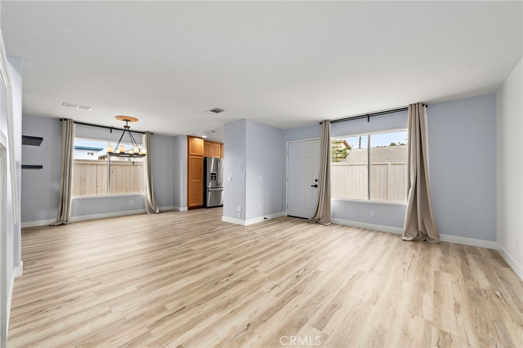 431 West Bay Street, Unit S Costa Mesa, CA 92627 - Photo 3 of 34 an empty room with wooden floor and windows