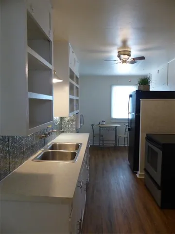 a kitchen with a sink cabinets and stainless steel appliances