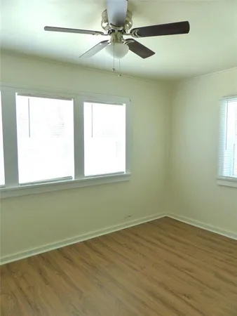 a view of a room with wooden floor and windows