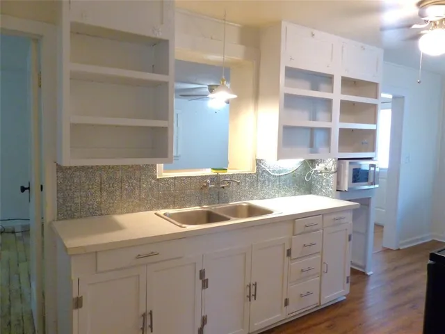 a kitchen with a sink and cabinets