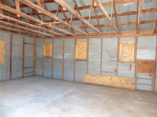 a view of an empty room with windows