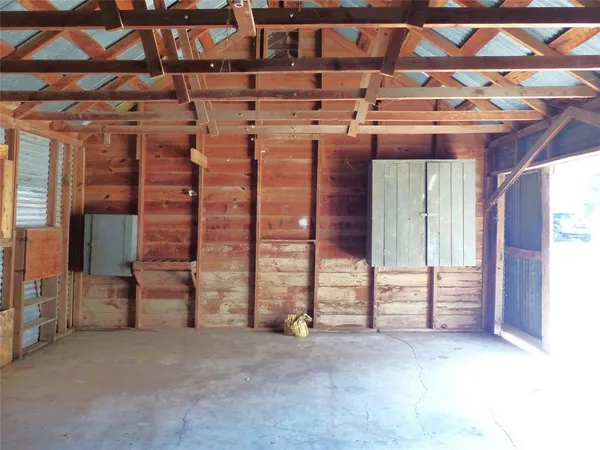 a view of an empty room with wooden shelves
