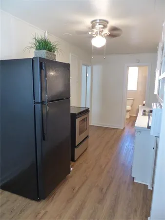 a kitchen with stainless steel appliances granite countertop a refrigerator a sink and a refrigerator