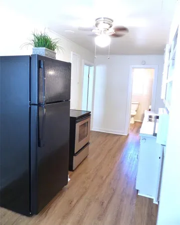 a view of a kitchen from a hallway