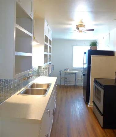 a kitchen with a wooden floor and a sink
