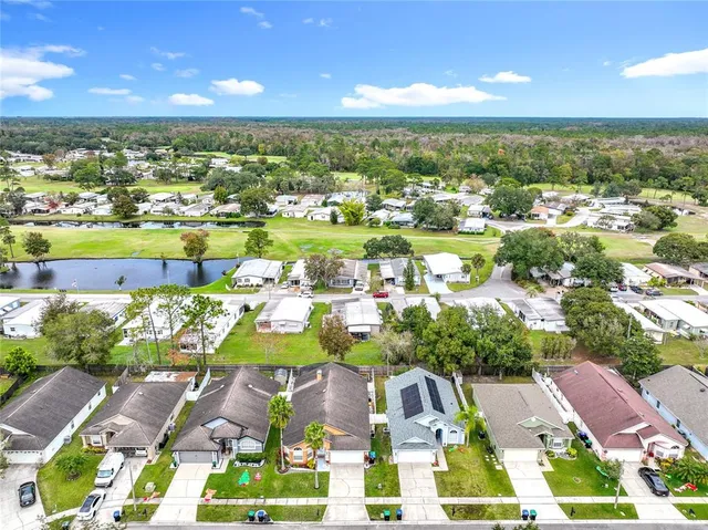 a view of a city with lots of residential buildings ocean and mountain view in back