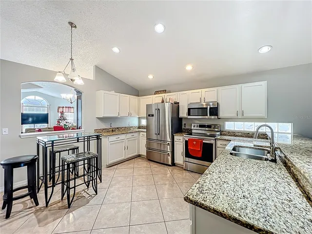 a kitchen with stainless steel appliances granite countertop a sink counter space and cabinets
