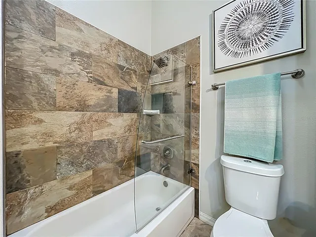 a bathroom with a toilet and a shower