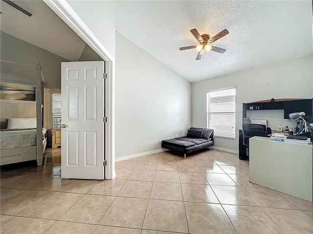 a view of a livingroom with furniture and a ceiling fan