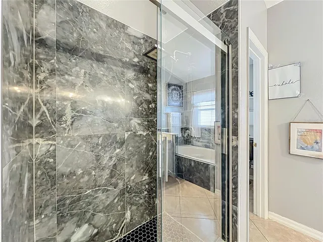 a bathroom with a bathtub and shower