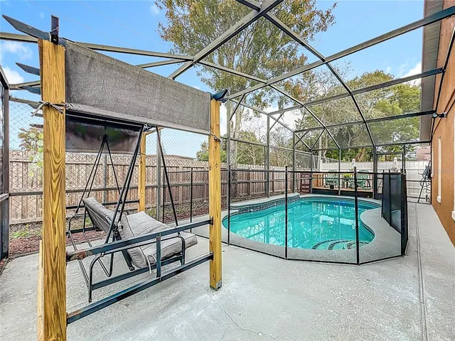 a view of a backyard with a swimming pool