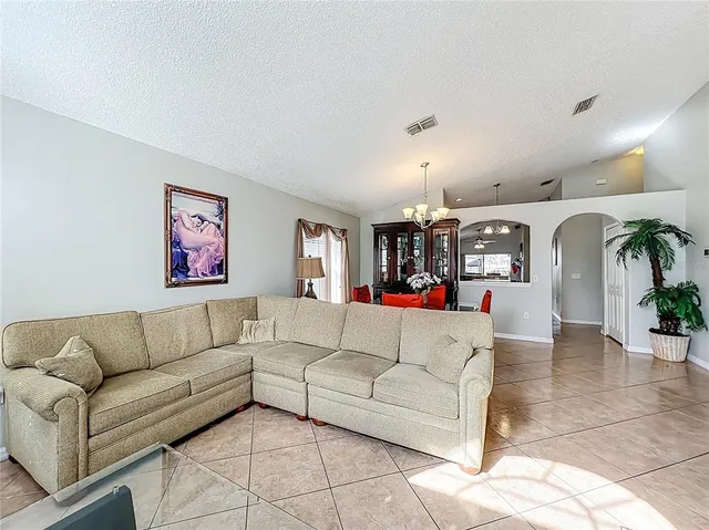 a living room with furniture and kitchen view