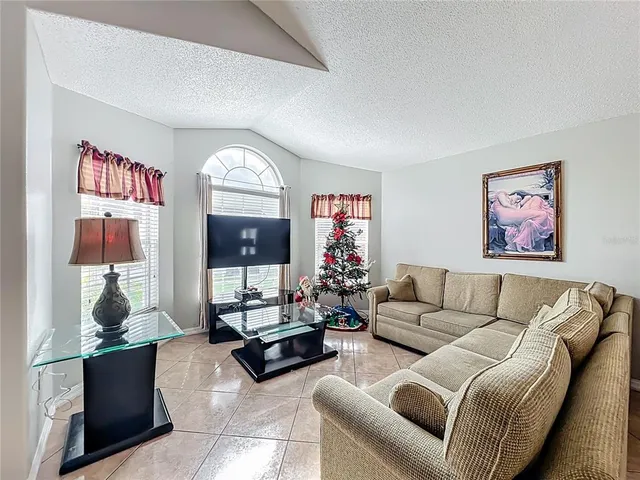 a living room with furniture a rug and a flat screen tv