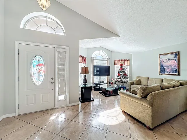 a living room with furniture a rug and a window