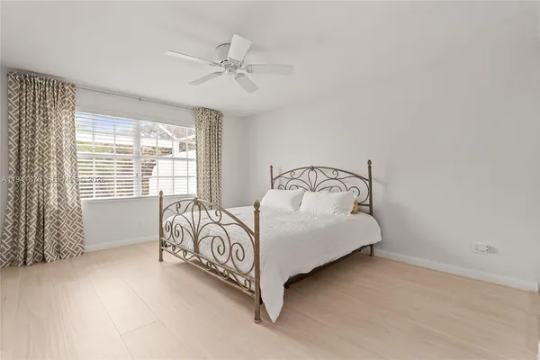 a bed sitting in a bedroom next to a window