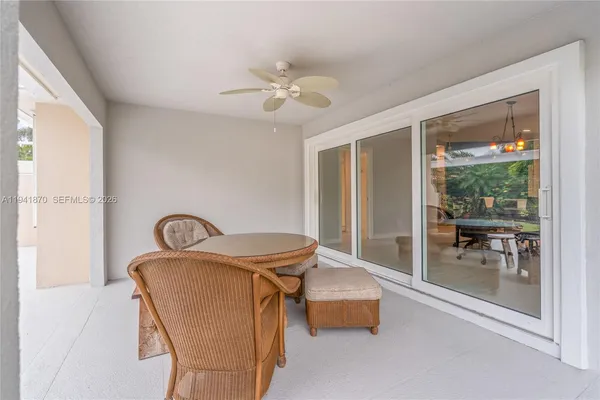 a dining room with furniture and a floor to ceiling window