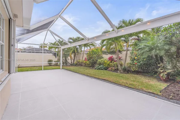 a view of a backyard with a garden and entertaining space