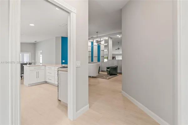 a view of a living room hardwood floor and a kitchen