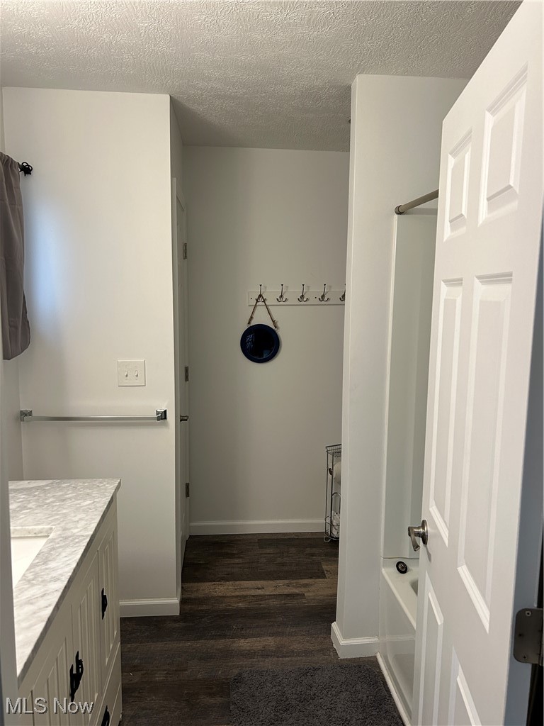 3005 Bardshar Road Sandusky, OH 44870 - Photo 20 of 24 Full bathroom with a textured ceiling, vanity, baseboards, and wood finished floors