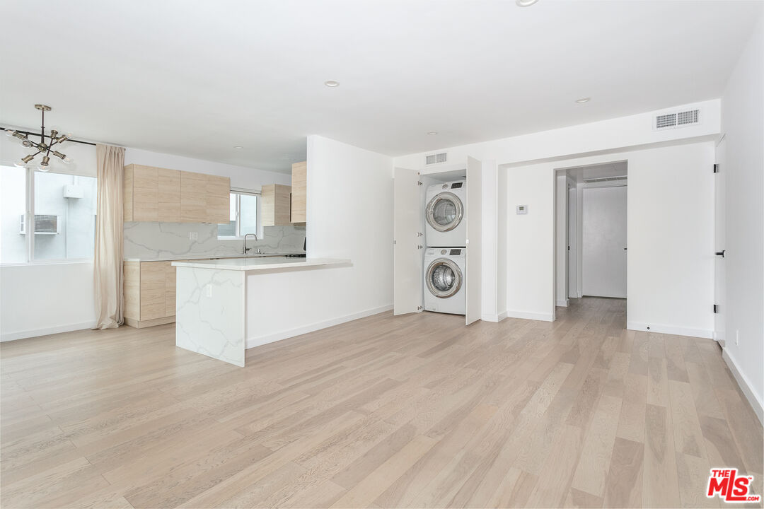560 Kings Road, Unit 4 Los Angeles, CA 90048 - Photo 2 of 10 a view of a kitchen with a sink cabinets and a wooden floor