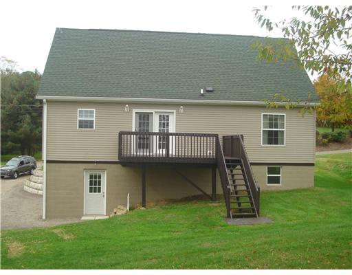 132 Hepler Road Sarver, PA 16055 - Photo 3 of 15 Exterior Back. FRENCH DOORS OFF OF THE DINING AREA TO THIS LARGE DECK TO THE BACK YARD.