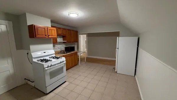 a kitchen with stainless steel appliances granite countertop a stove and a refrigerator
