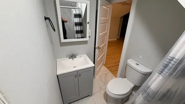 a white toilet sitting next to a bathroom sink