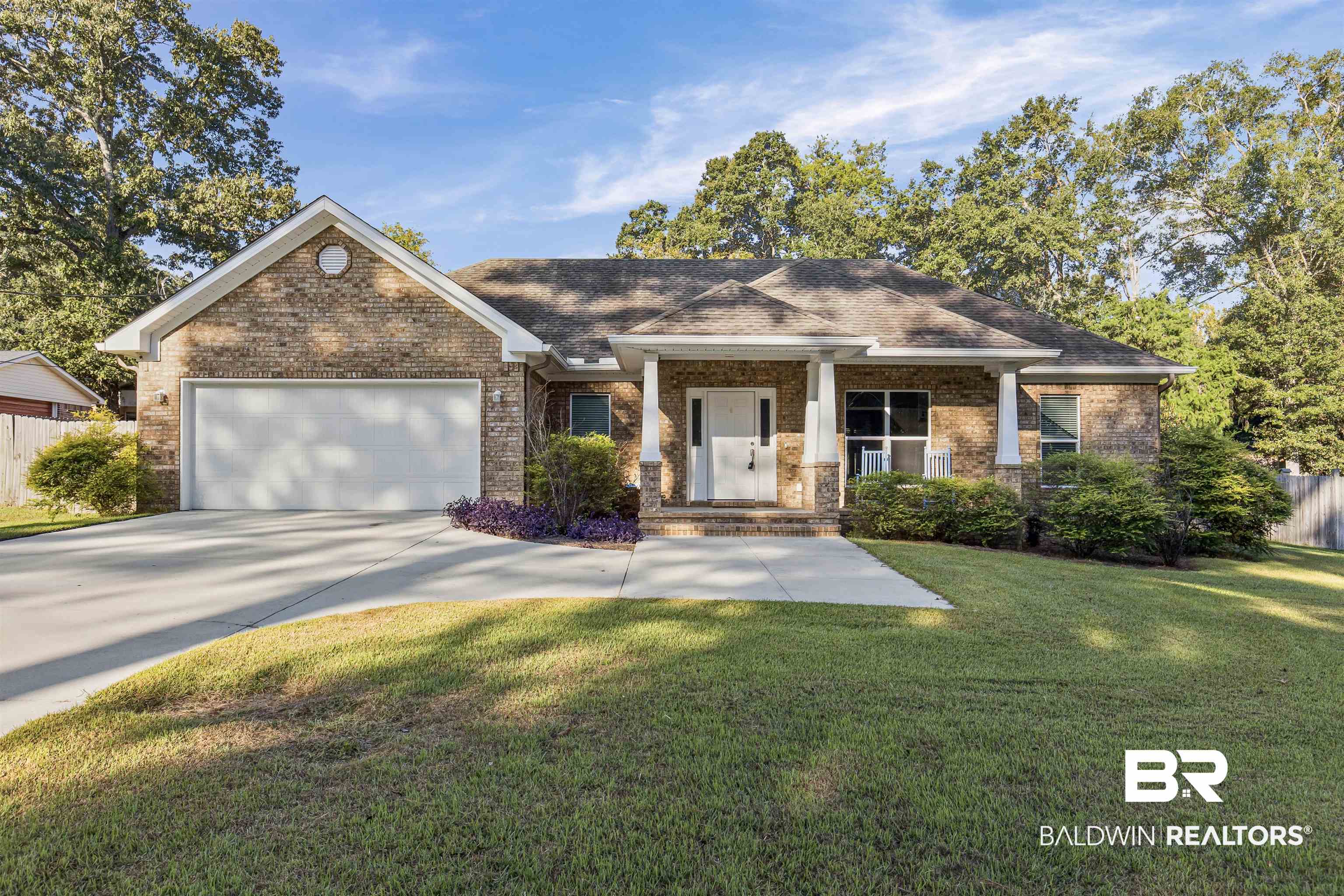 30851 Joseph Drive Spanish Fort, AL 36527 - Photo 1 of 22 View of front of house featuring a porch, brick siding, concrete driveway, a garage, and a shingled roof