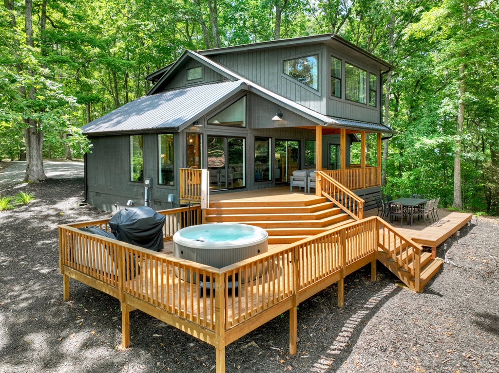65 Highland Tower Road Blue Ridge, GA 30513 - Photo 39 of 48 a backyard of a house with barbeque oven table and chairs