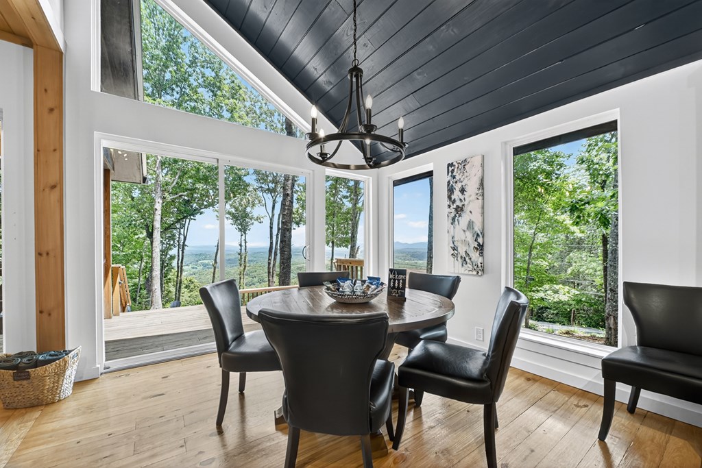 65 Highland Tower Road Blue Ridge, GA 30513 - Photo 9 of 48 a dining room with furniture a chandelier and wooden floor