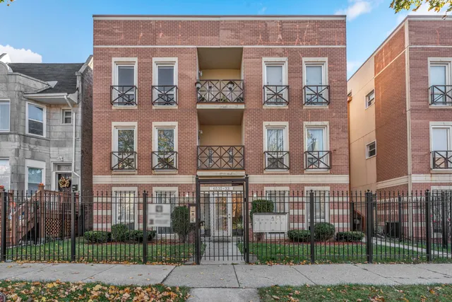a view of a brick building next to a yard
