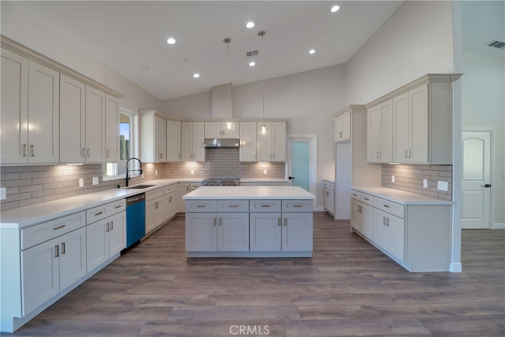14785 Tigertail Road Apple Valley, CA 92307 - Photo 4 of 20 a large kitchen with kitchen island a sink stainless steel appliances and cabinets
