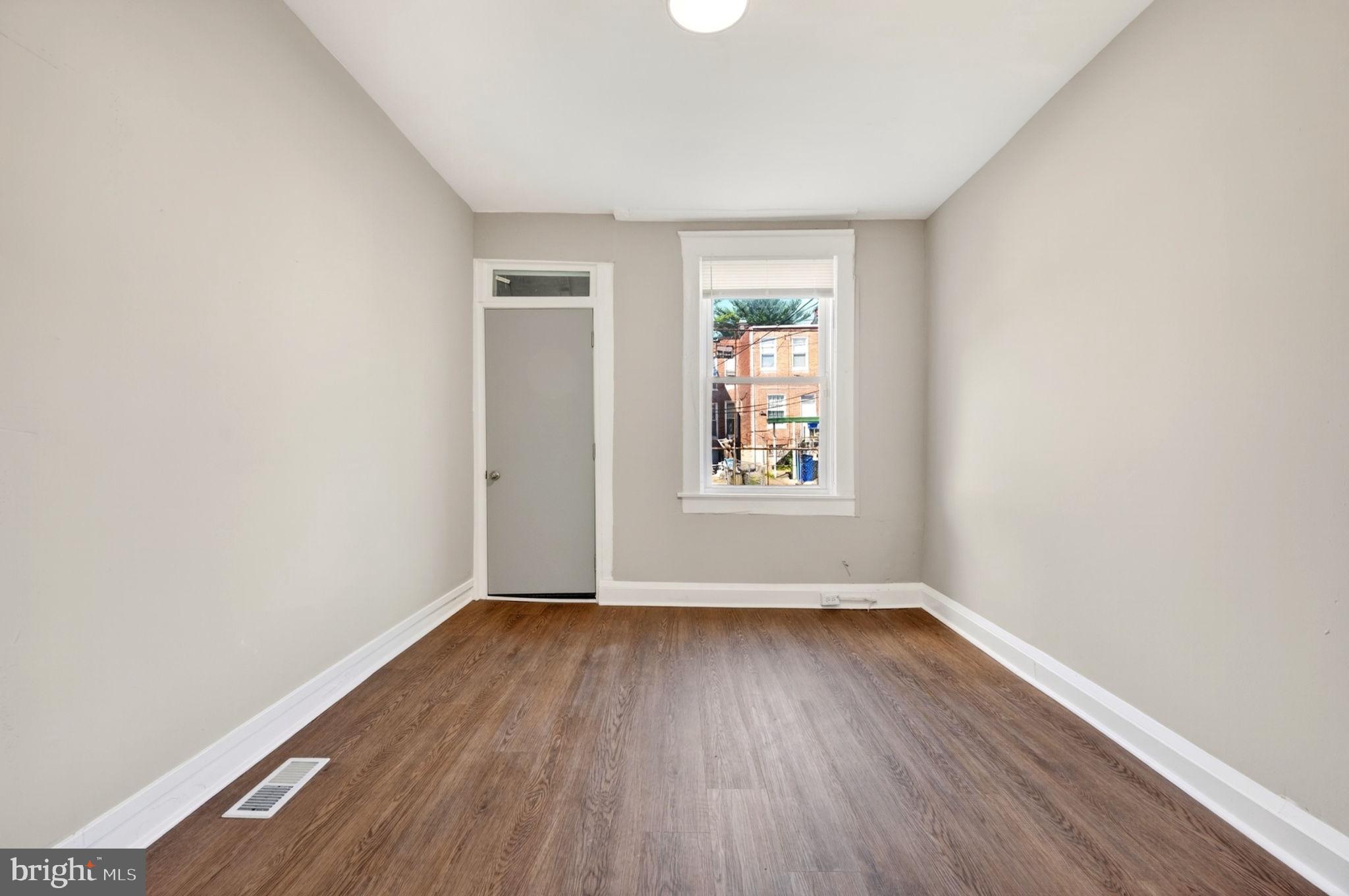 1358 Homestead Street Baltimore, MD 21218 - Photo 12 of 35 an empty room with window and wooden floor