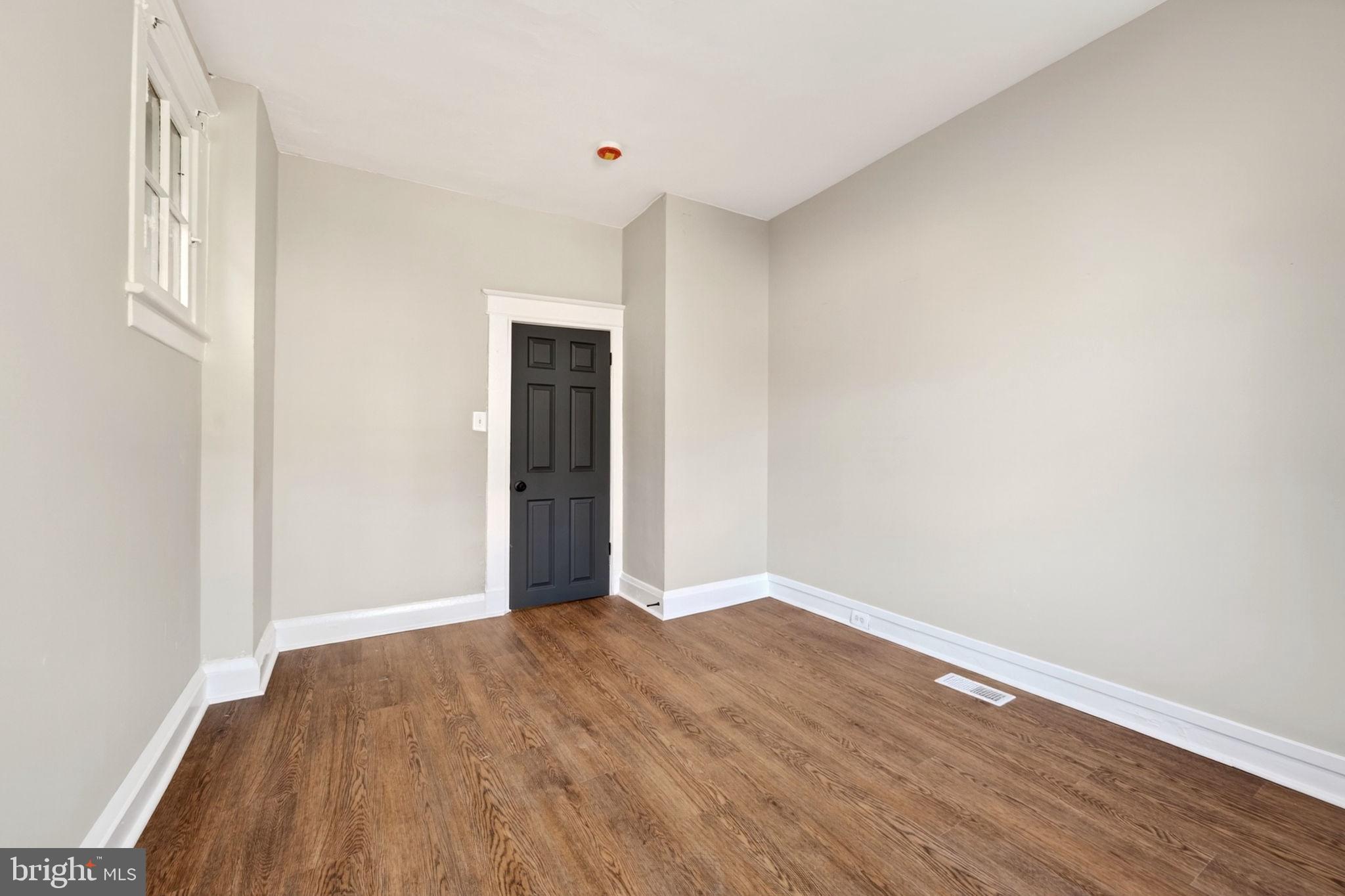 1358 Homestead Street Baltimore, MD 21218 - Photo 13 of 35 a view of an empty room with wooden floor
